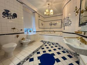 a bathroom with a toilet and a sink and a tub at City Honor Extravagance in Linz +18 photos