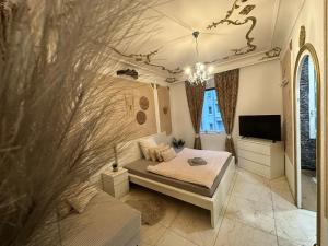 a bedroom with a bed and a tv in a room at City Honor Extravagance in Linz