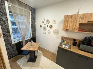 a kitchen with a wooden table and a sink at City Honor Extravagance in Linz