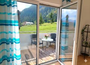 a balcony with a table and a view of a mountain at Ferienwohnungen Apart Diana in Vils
