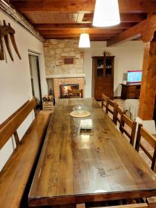a large wooden table in a room with a fireplace at Alameda I CURIEL DE DUERO in Curiel de Duero