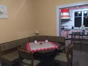 a restaurant with a table and chairs with a red and white table cloth at 1 Chambre d hôtes dans un écrin de verdure in Dambach +4 photos