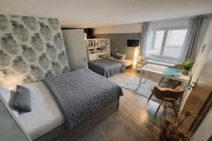 a bedroom with a bed and a desk and a room at Wohnung mit Charme, Netflix in Rheinstetten