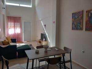 a living room with a table and a couch at loft ΑLEXIA in Pyrgos