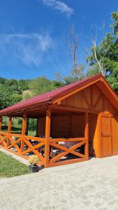 a large wooden pavilion with a red roof at Apartmány U GUNÁRA Vyhne - Apartmán Akácia in Vyhne