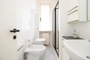 a white bathroom with a toilet and a sink at Casa Vacanze Marcelli51 - Soggiorni Le Grotte in Marcelli