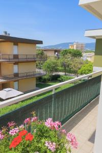 a balcony of a building with flowers at Casa Vacanze Marcelli51 - Soggiorni Le Grotte in Marcelli