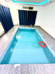 a swimming pool with a red hose on top of it at شاليهات زارا Zara in Taif