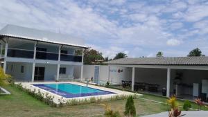 a house with a swimming pool in front of it at Villa Beija-flor in Camacari