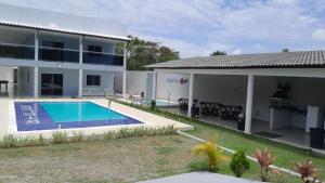 a house with a swimming pool in front of it at Villa Beija-flor in Camacari