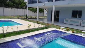 a swimming pool in the backyard of a house at Villa Beija-flor in Camacari