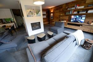 a living room with a couch and a chair at Chamonix Balcons du Mont Blanc in Chamonix-Mont-Blanc