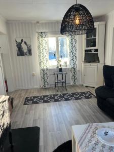 a living room with a couch and a table at Oleby Källbacken in Torsby