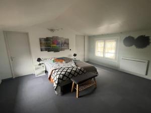 a bedroom with a bed and a window at Maison de Nathony in Maisons-en-Champagne