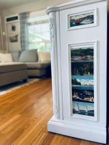 a white picture frame sitting on the floor in a living room at Copper Voyage, Fenced Backyard in Coeur d'Alene