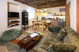 a living room with a couch and a table at Sweet Home 119 spa privé in Château-Ville-Vieille