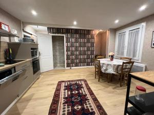 a kitchen with a table and a dining room at Maison de Nathony in Maisons-en-Champagne