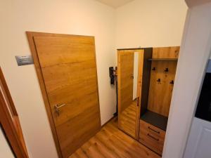 a room with a wooden door and a hallway at Pension Kronenburghof in Erfurt
