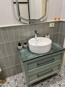 a bathroom with a sink and a mirror at Bilgeh Old House Villa in Baku +9 photos