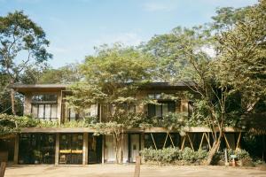 a building with trees in front of it at Mar Botánico - Avellanas Beach Hotel in Playa Avellana