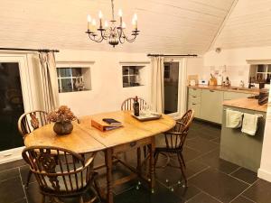 a kitchen with a wooden table and chairs at Westgaerde20 in Dwingeloo +24 photos