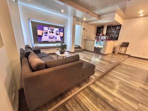 a living room with a couch and a flat screen tv at Lavid Hotel Kennedy in Bogotá