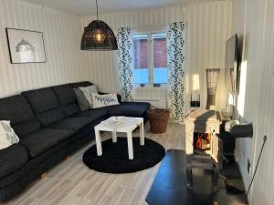 a living room with a couch and a fire place at Oleby Källbacken in Torsby