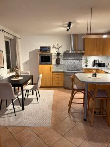 a kitchen with two tables and chairs in a room at MarktQuartier Bad Schandau in Bad Schandau