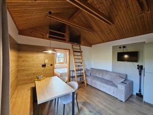 a living room with a couch and a table at Tatralandia Chatka 112 in Liptovský Mikuláš
