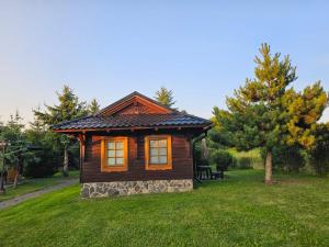 a small cabin in the middle of a grass field at Tatralandia Chatka 112 in Liptovský Mikuláš