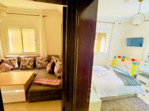 a living room with a bed and a couch at Dar La Madina Essaouira in Essaouira