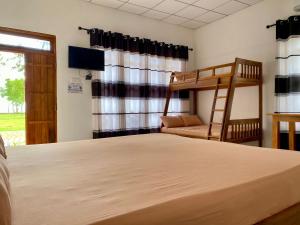 a bedroom with a bunk bed and a bunk at The Corel Waves Inn in Kalkudah