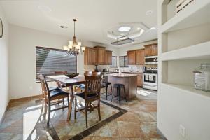 a kitchen with a dining room table and chairs at The Palo in Alamogordo