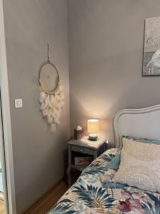 a bedroom with a bed and a table with a lamp at L'écrin vert in Villelongue-dʼAude +38 photos