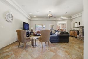 a living room with a couch and a table and chairs at The Palo in Alamogordo
