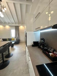 a kitchen with a table and a living room at Theros 2 in Xanthi