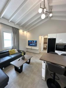 a living room with a couch and a table at Theros 2 in Xanthi