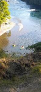 two people in canoes in a body of water at camping los hualles in Lago Ranco