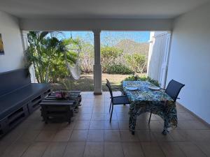 a dining room with a table and chairs and a couch at Sxm Caribbean Nest in Saint Martin +12 photos
