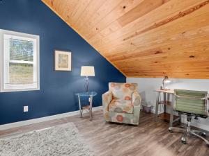 a room with a chair and a wooden ceiling at Jax Joint - Pet Friendly - Perfect Family Vacation Spot! in Crane Hill