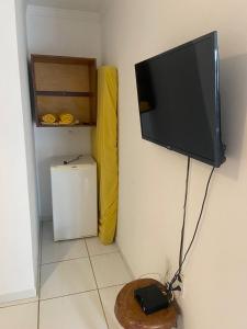 a flat screen tv hanging on a wall at Luar Dos Milagres in São Miguel dos Milagres