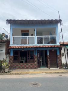 a blue and white house with a balcony at Luar Dos Milagres in São Miguel dos Milagres