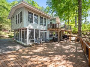 a large house with a deck and a porch at Sheltered Cove - Family-Friendly With Lots Of Options! in Jasper