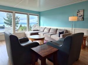 a living room with a couch and chairs and a table at Saltwater Beach Home with Ocean View in Des Moines