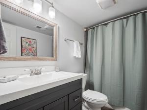a bathroom with a sink and a toilet and a mirror at Sheltered Cove - Family-Friendly With Lots Of Options! in Jasper +30 photos