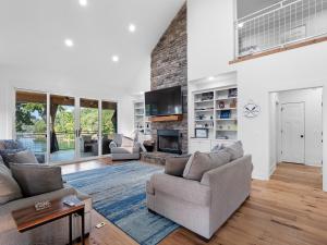 a living room with two couches and a fireplace at Sweet Retreat - Great Views Of The Lake! in Houston