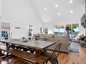 a living room with a wooden table and a couch at Sweet Retreat - Great Views Of The Lake! in Houston