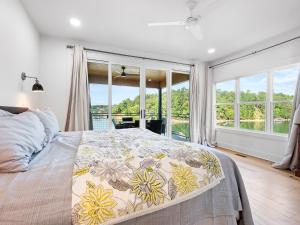 a bedroom with a bed and a large window at Sweet Retreat - Great Views Of The Lake! in Houston