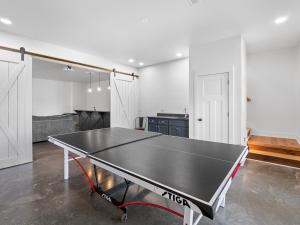 a ping pong table in the middle of a room at Sweet Retreat - Great Views Of The Lake! in Houston +23 photos