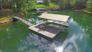 an aerial view of a dock in a lake at Rocking W - Screened In Porch And Lakeside Fire Pit! in Double Springs